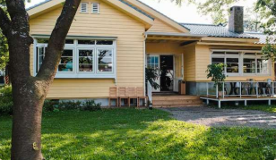 Yellow home in Killeen, TX with a front porch and an oak tree.